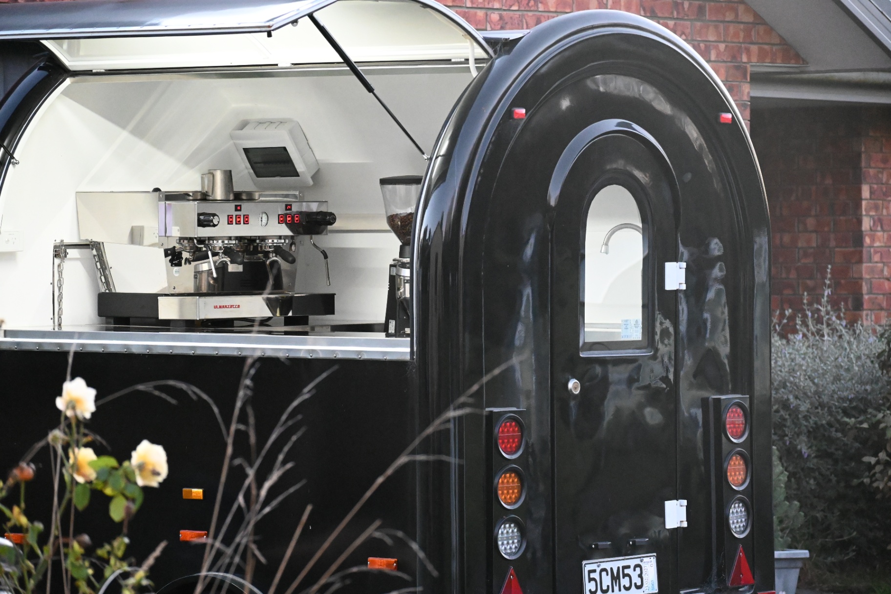 The double shot happy. coffee trailer with arched door, open and ready to serve